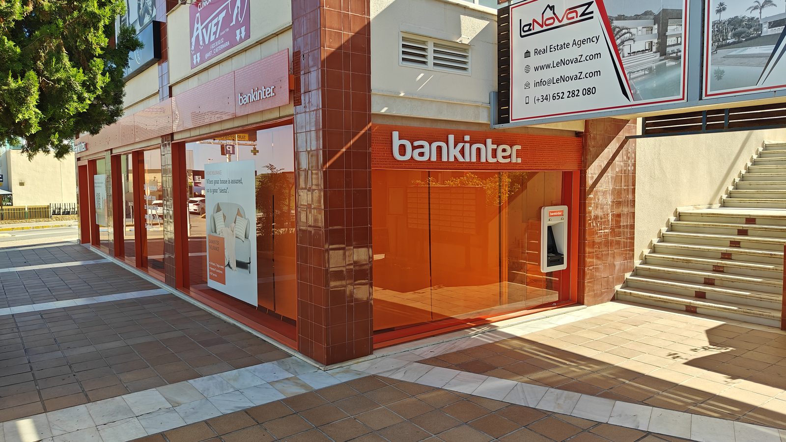 A bank branch and steps to the upper level of the shopping area in Los Dolses
