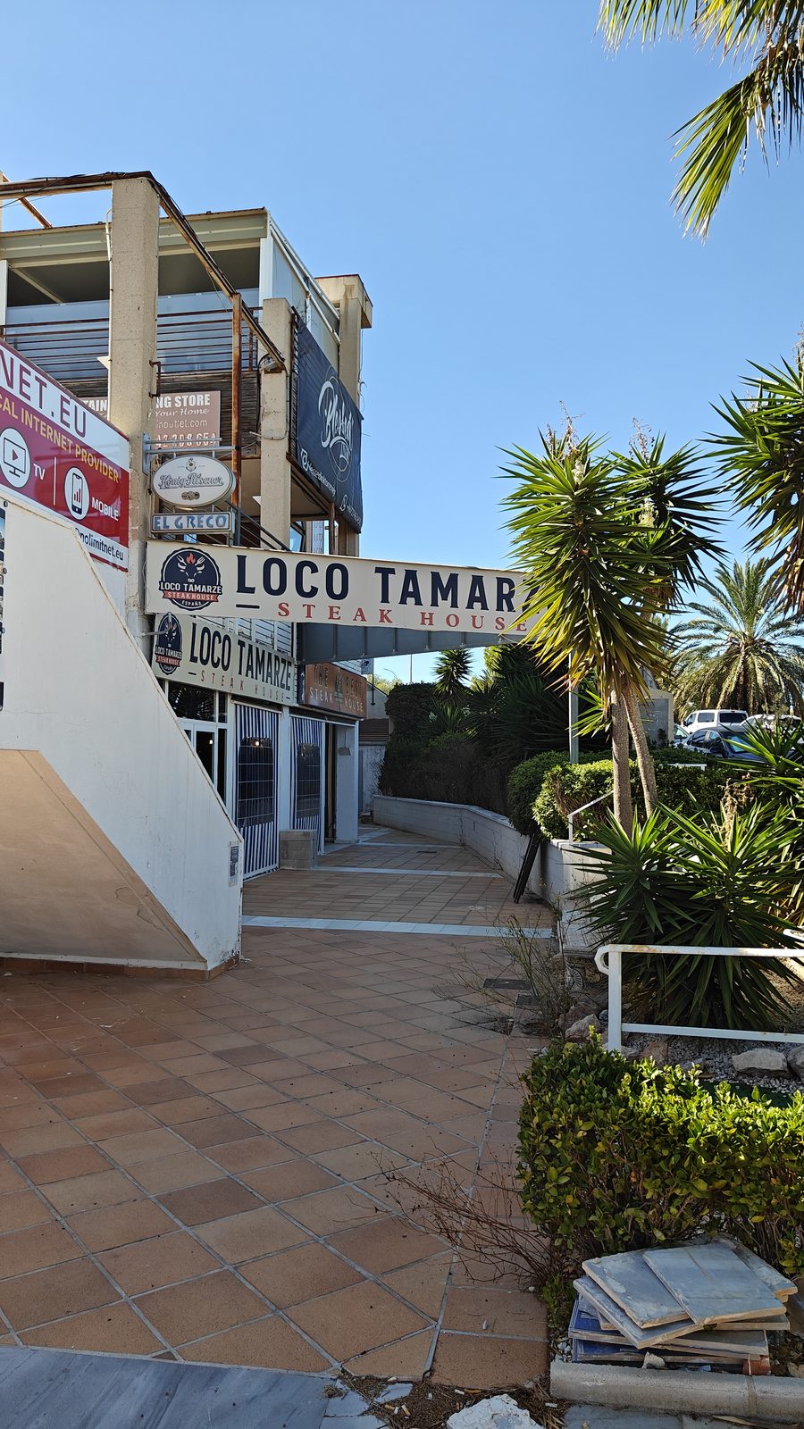 Garden path beside a restaurant entrance in Los Dolses