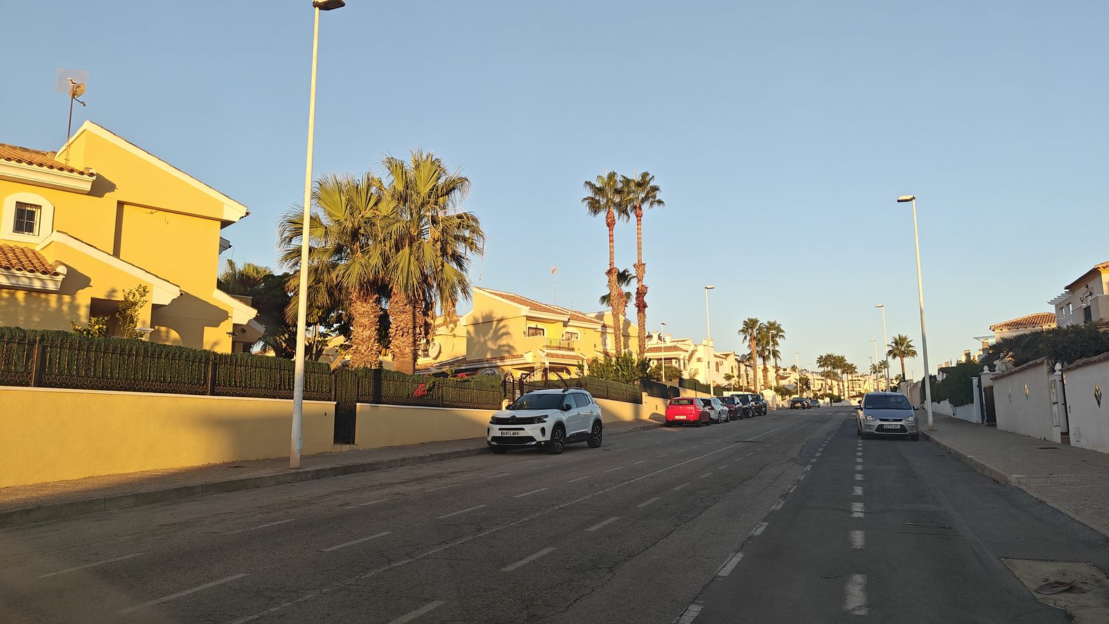 Quiet residential road in Los Dolses in early-morning sun